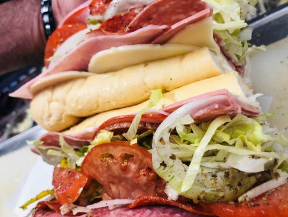 A close up of a sandwich and fries on a plate

Description automatically generated